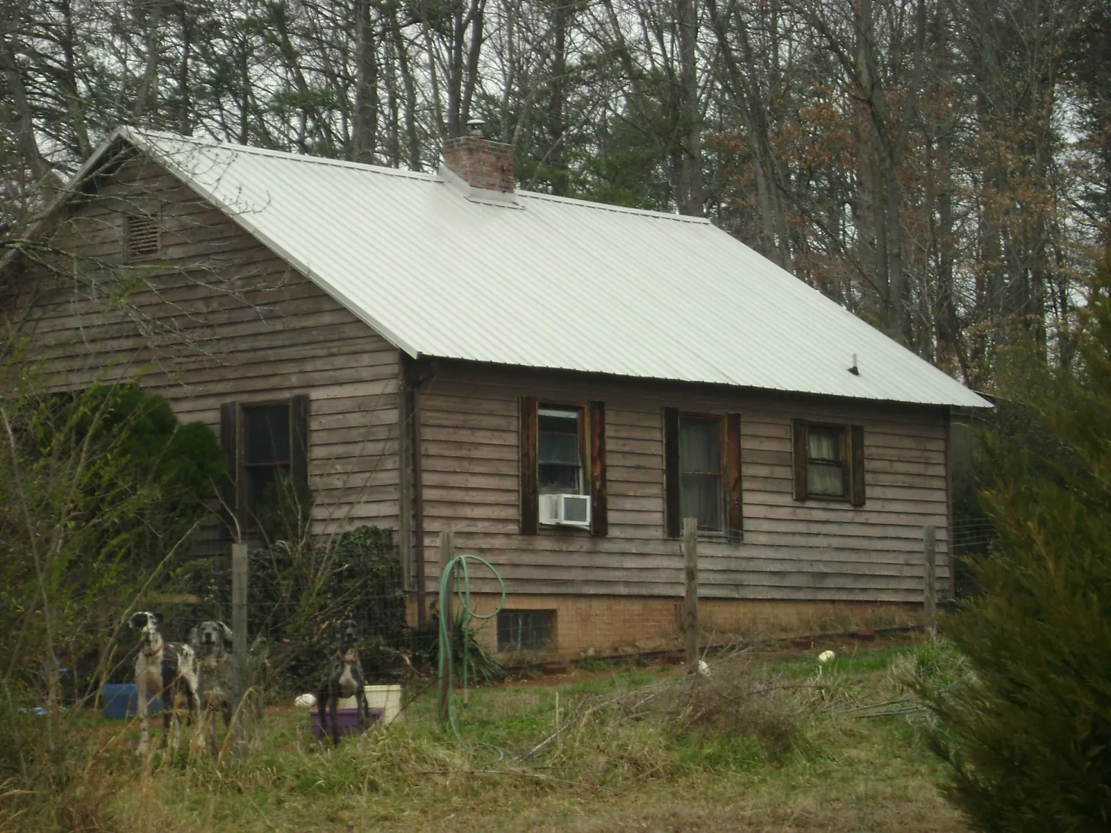 White metal roof on an old wood sided farmhouse, from a Asphalt Shingle Roof Repair job in Shipshewana